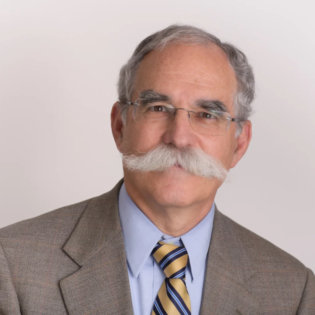 Headshot of Jonathan Fain, a mature gentleman with a mustache